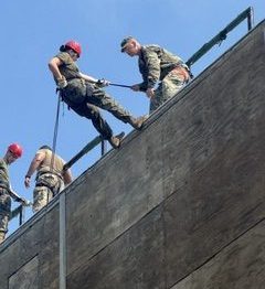 Salem High School Marine Corps JROTC student rappels down a building